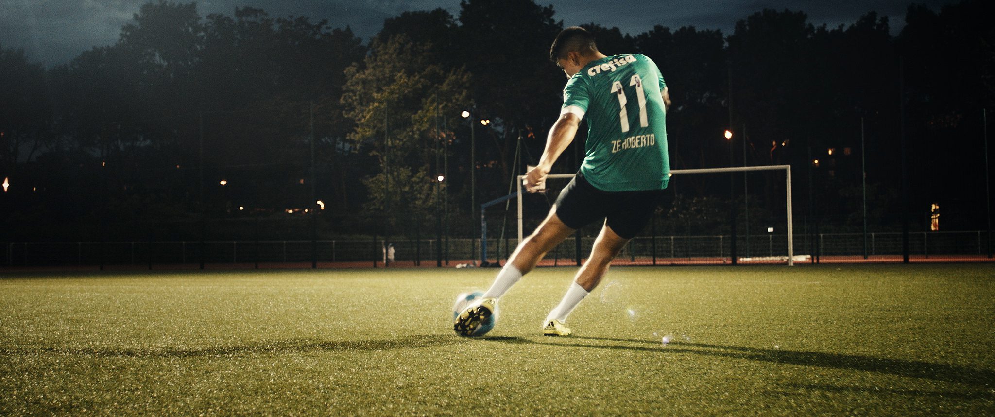 Soccer Player kicks the ball